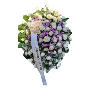 Arreglo fúnebre con rosas frescas y orquídeas hawaianas para condolencias en Cali.